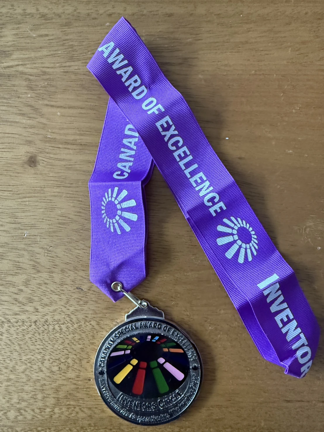 Award of Excellence medal with a purple ribbon