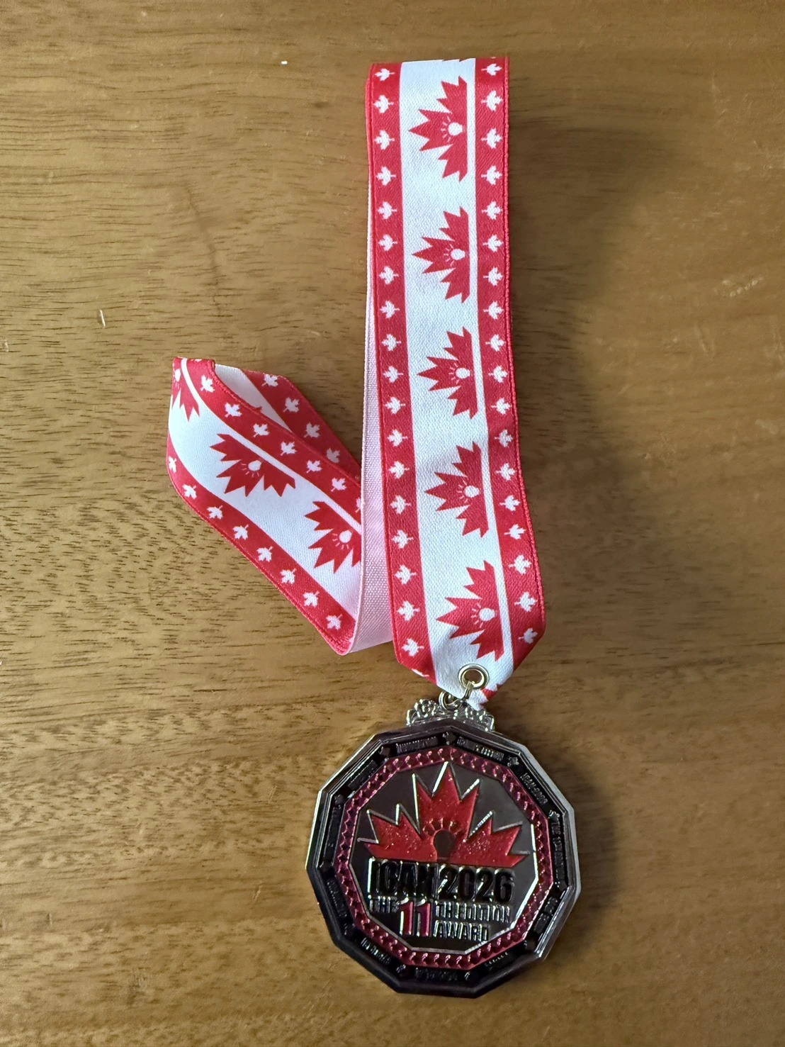 iCAN 2026 medal with a red maple-leaf ribbon